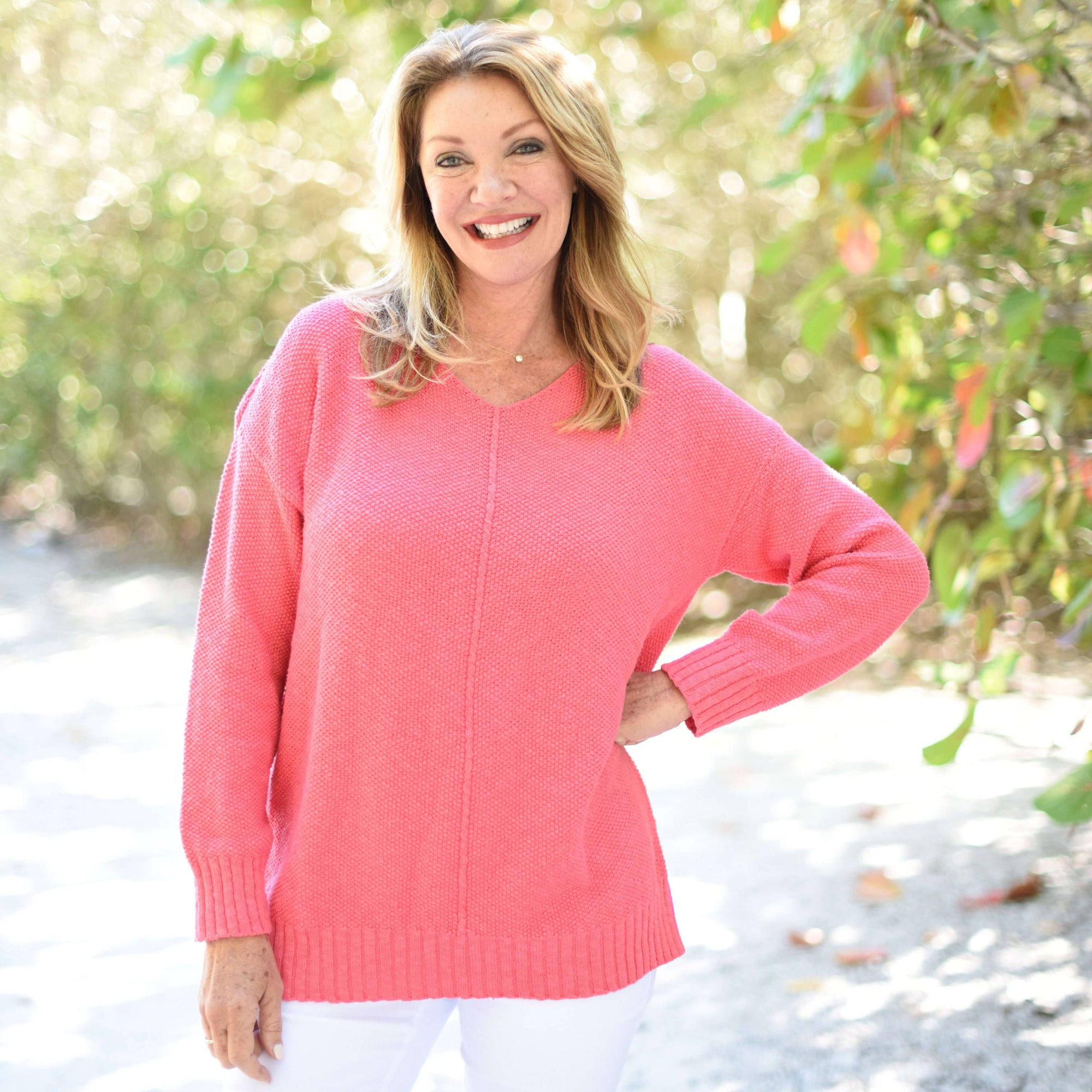 Woman in pink sweater with greenery