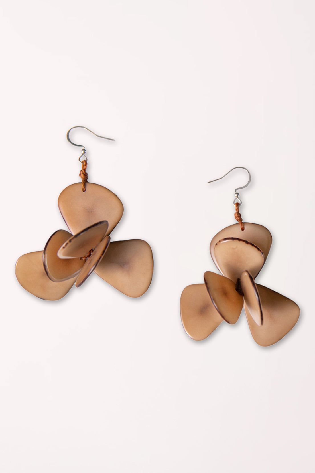 Pair of bronze propeller-shaped earrings on a white background