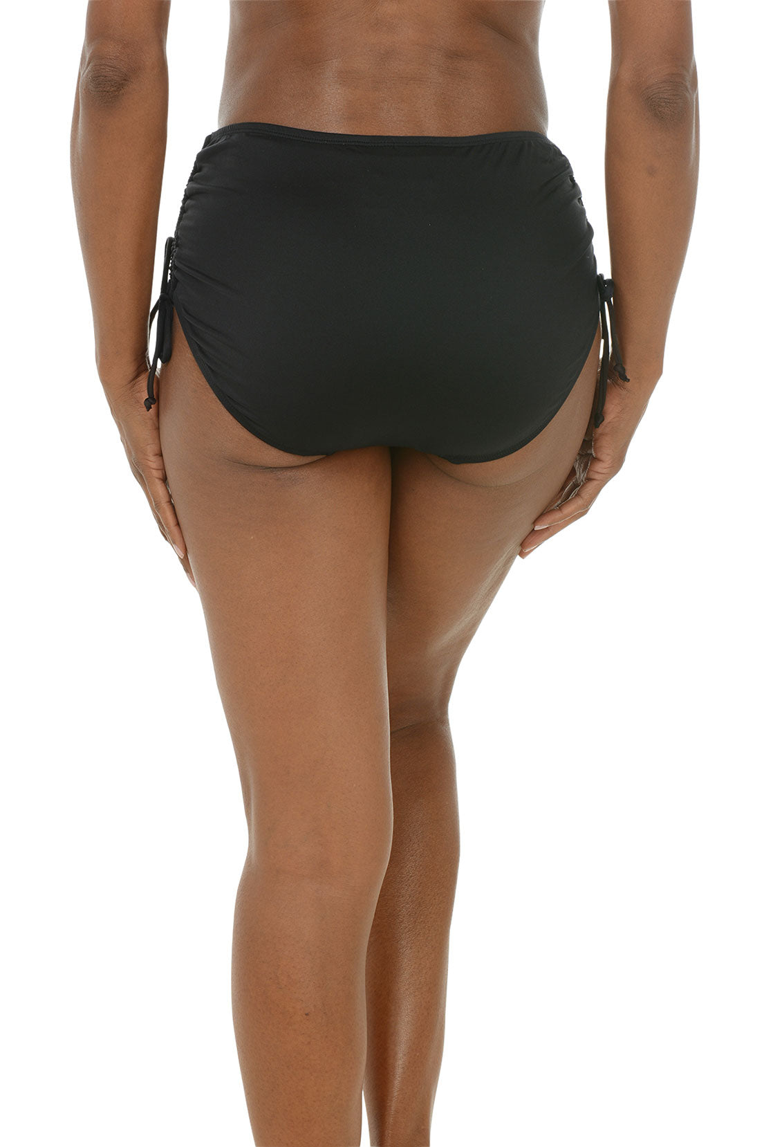 A back shot of a model wearing black full coverage swim briefs with adjustable side ties.