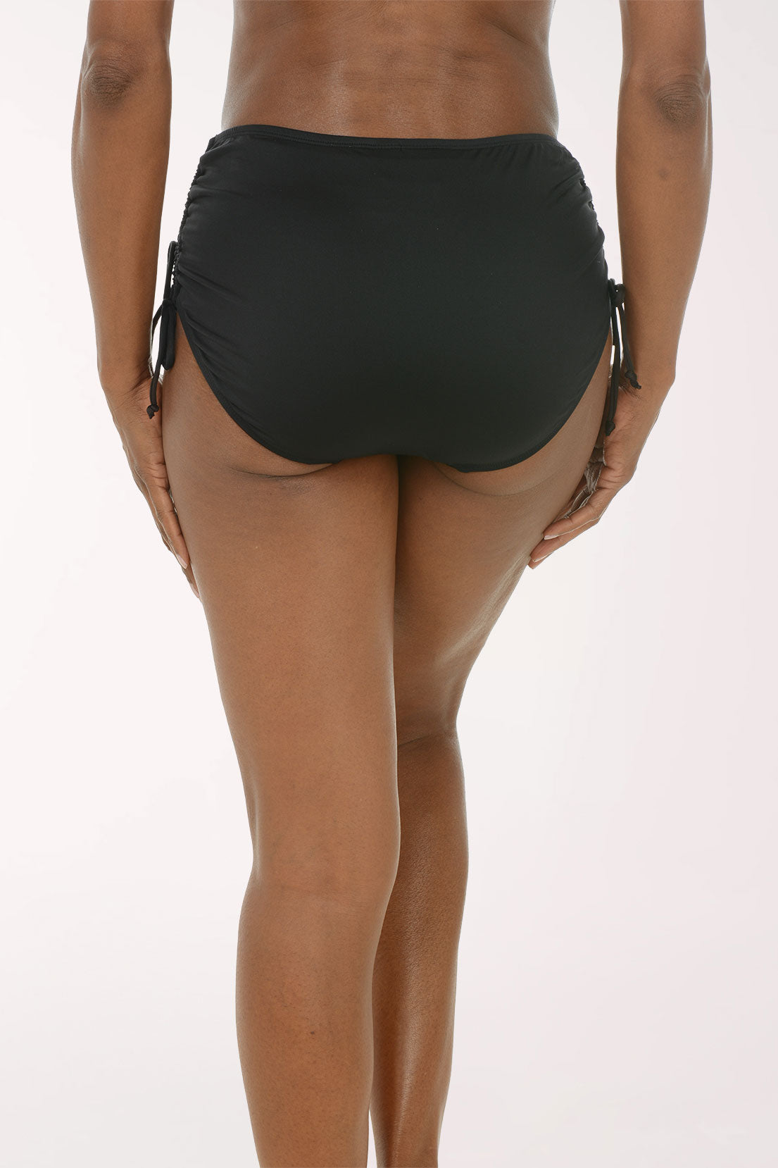Back view of the 24th and Ocean Adjustable Side Tie Swim Bottom in black, a full coverage brief with ruching at the sides.