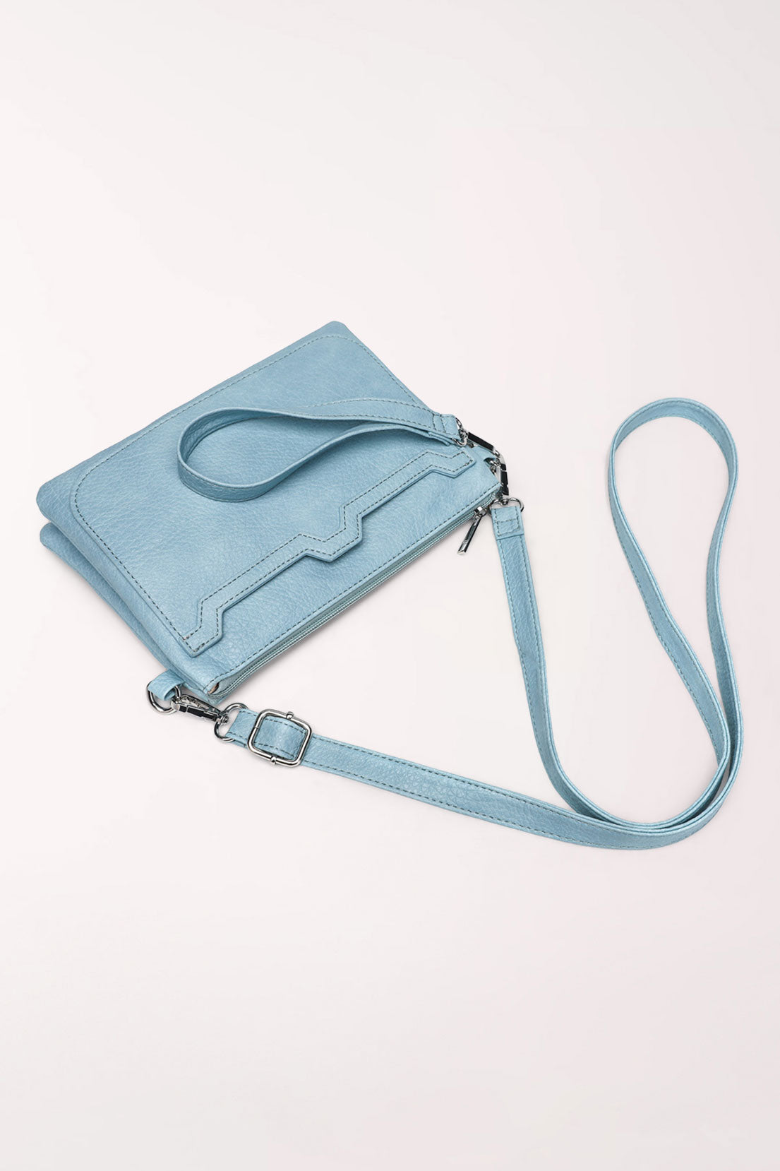 The baby blue 22 Tote Two-Sided Crossbody Bag lying flat with its wrist strap and long crossbody strap attached.