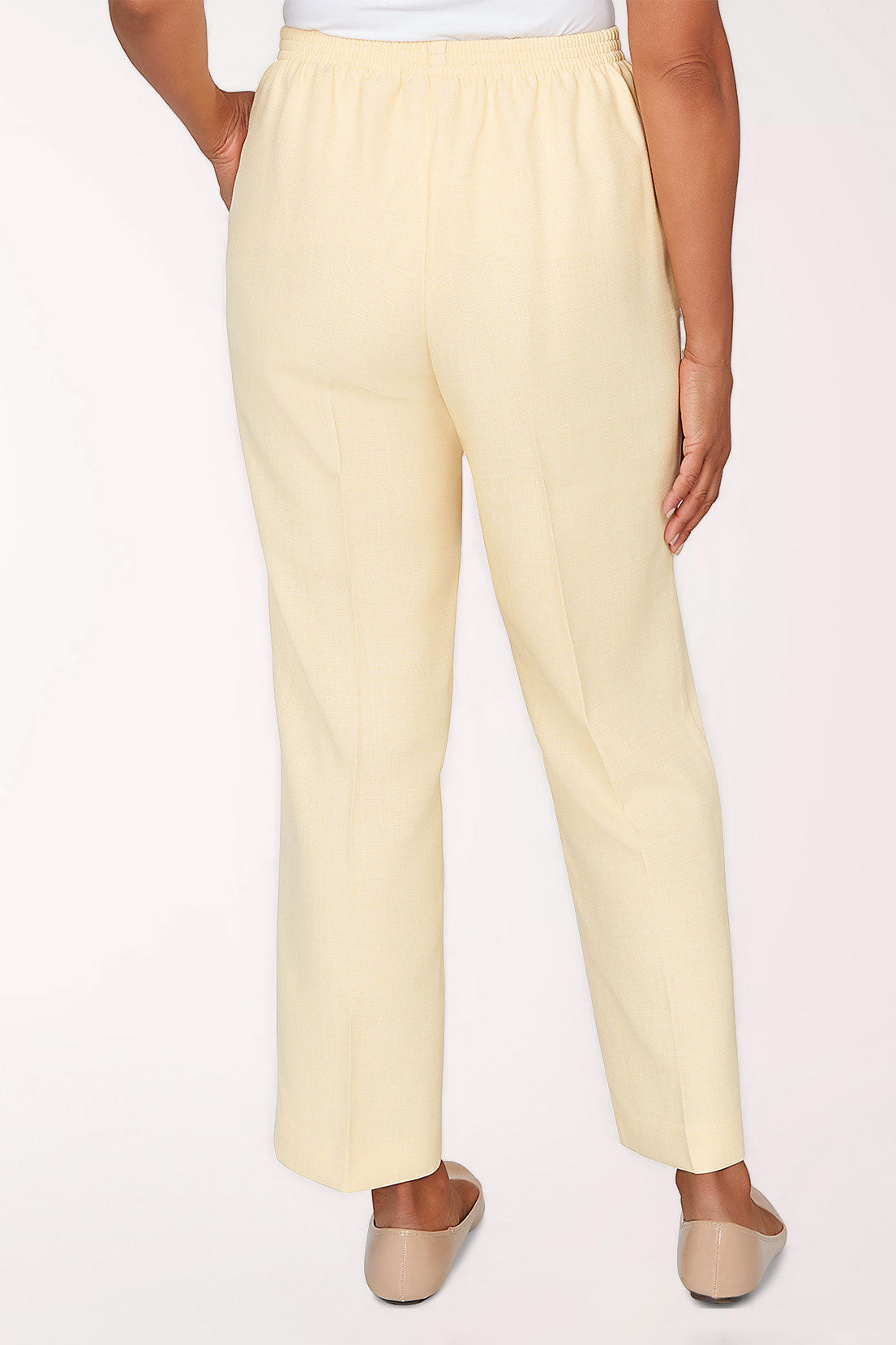 Light yellow pants worn by a person on a white background