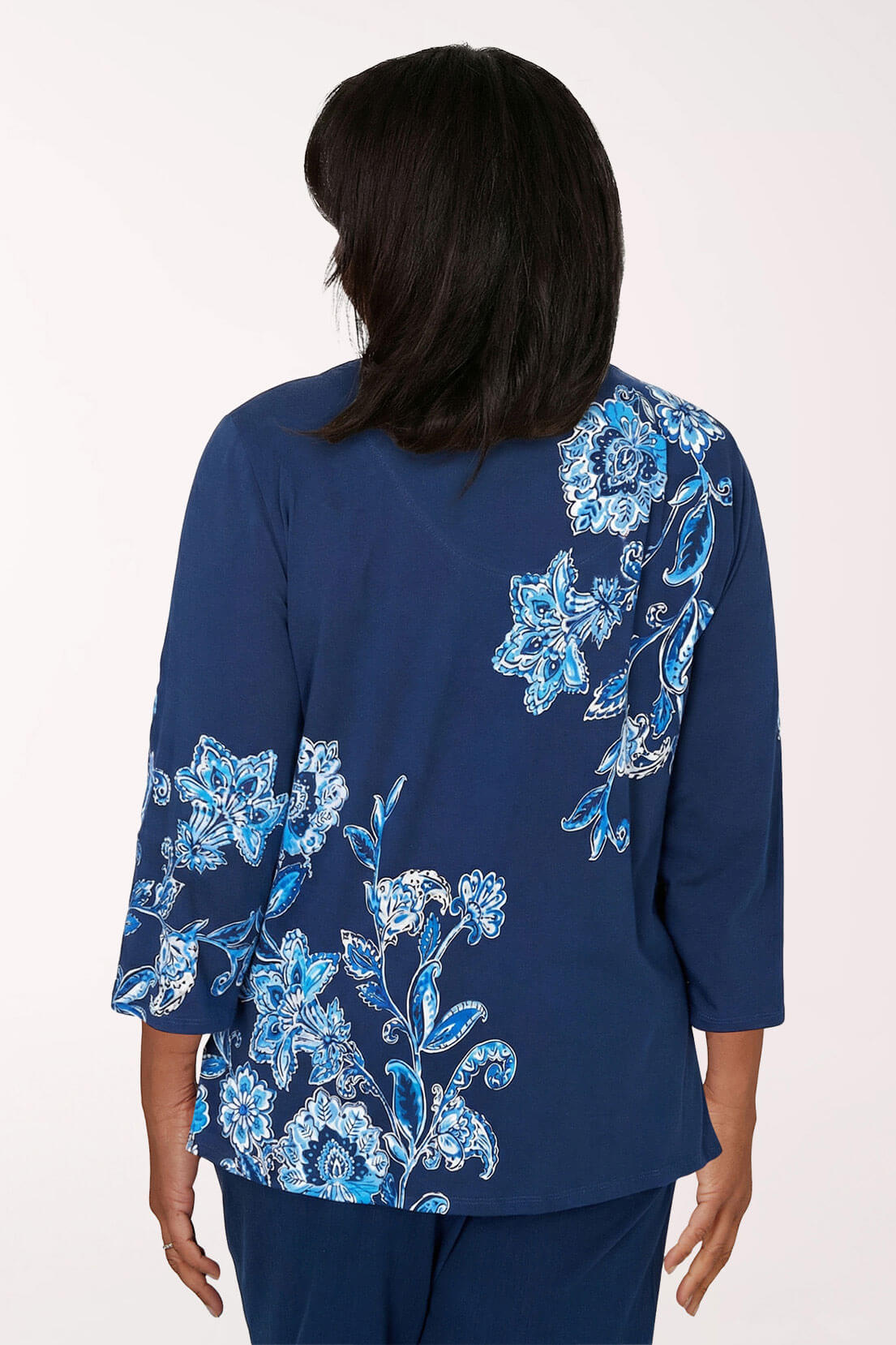 Navy blue blouse with blue floral patterns on a white background