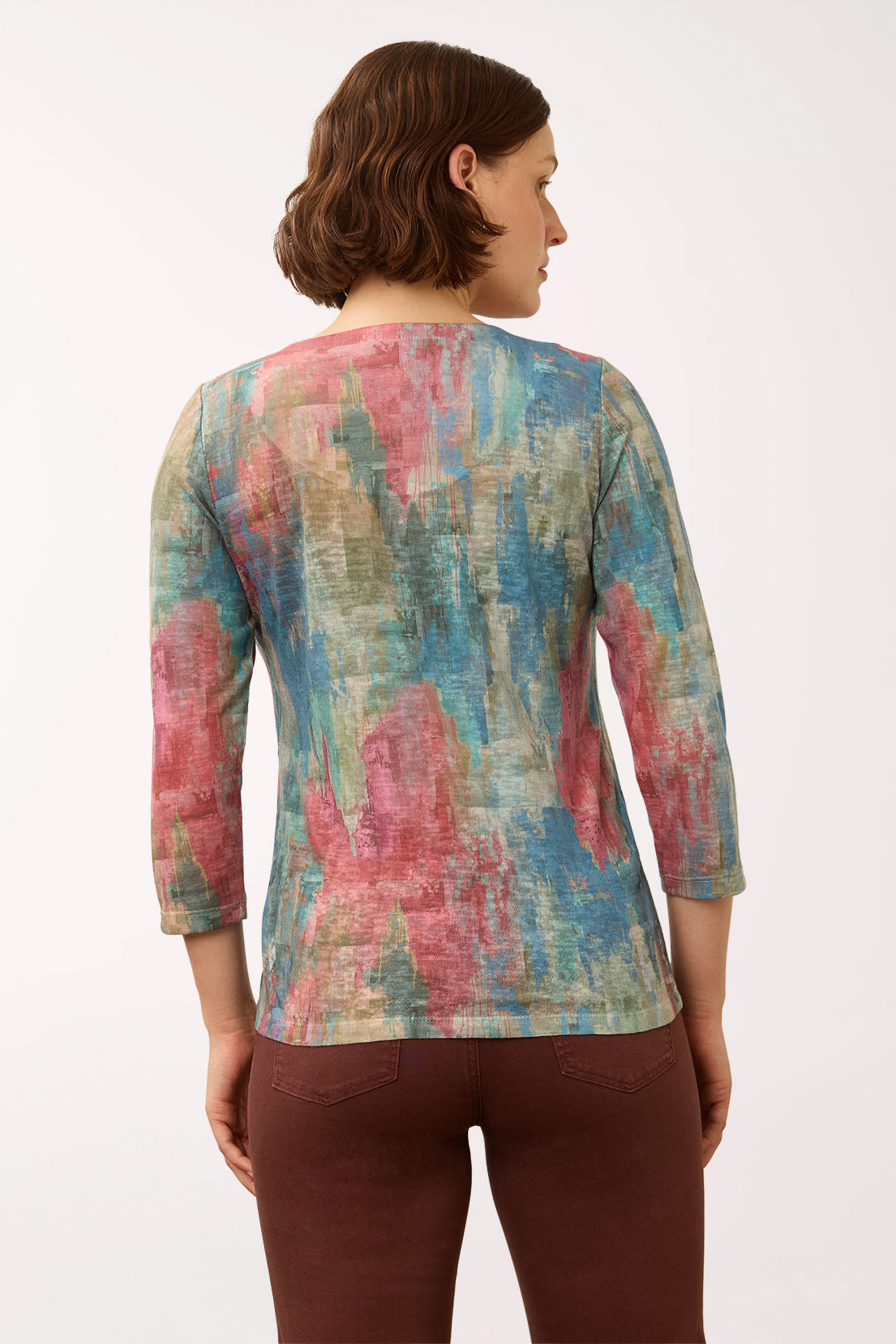 Woman wearing a 3/4 sleeve multicolored top