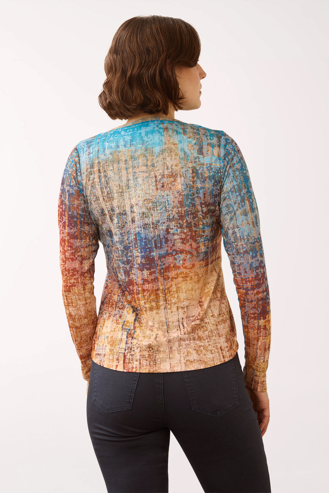 Woman wearing a 3/4 sleeve multicolored v-neck top