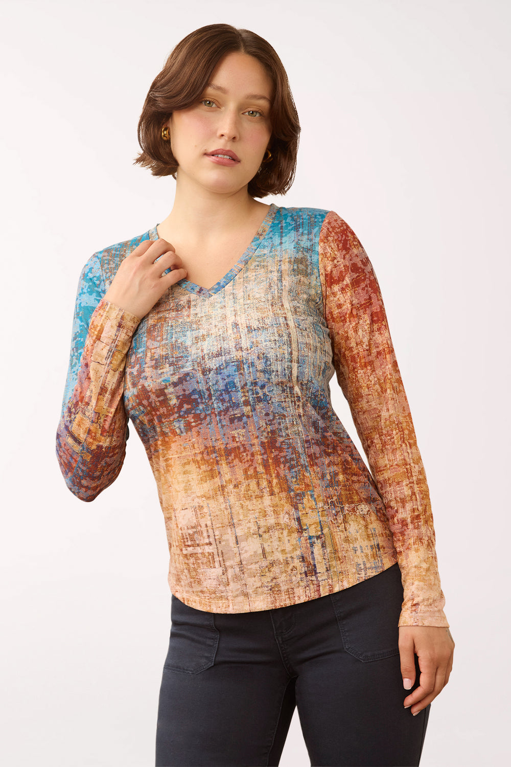 Woman wearing a 3/4 sleeve multicolored v-neck top