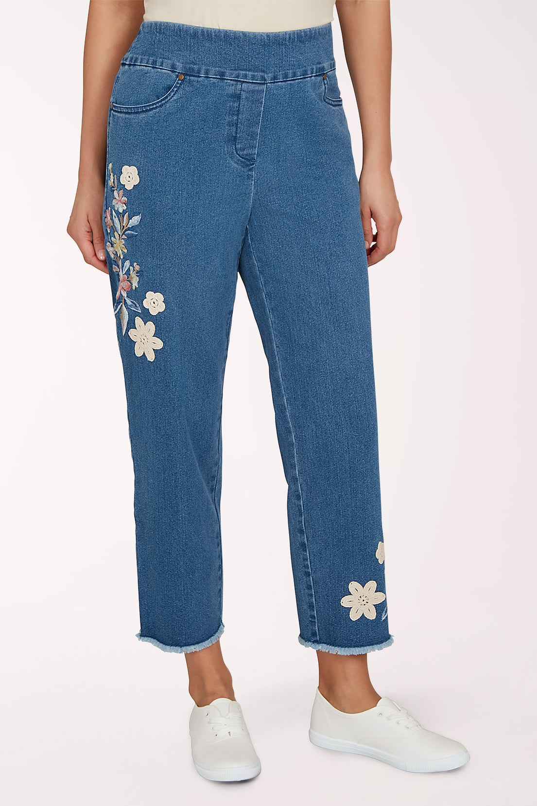 Woman wearing a denim crop pant with a floral design