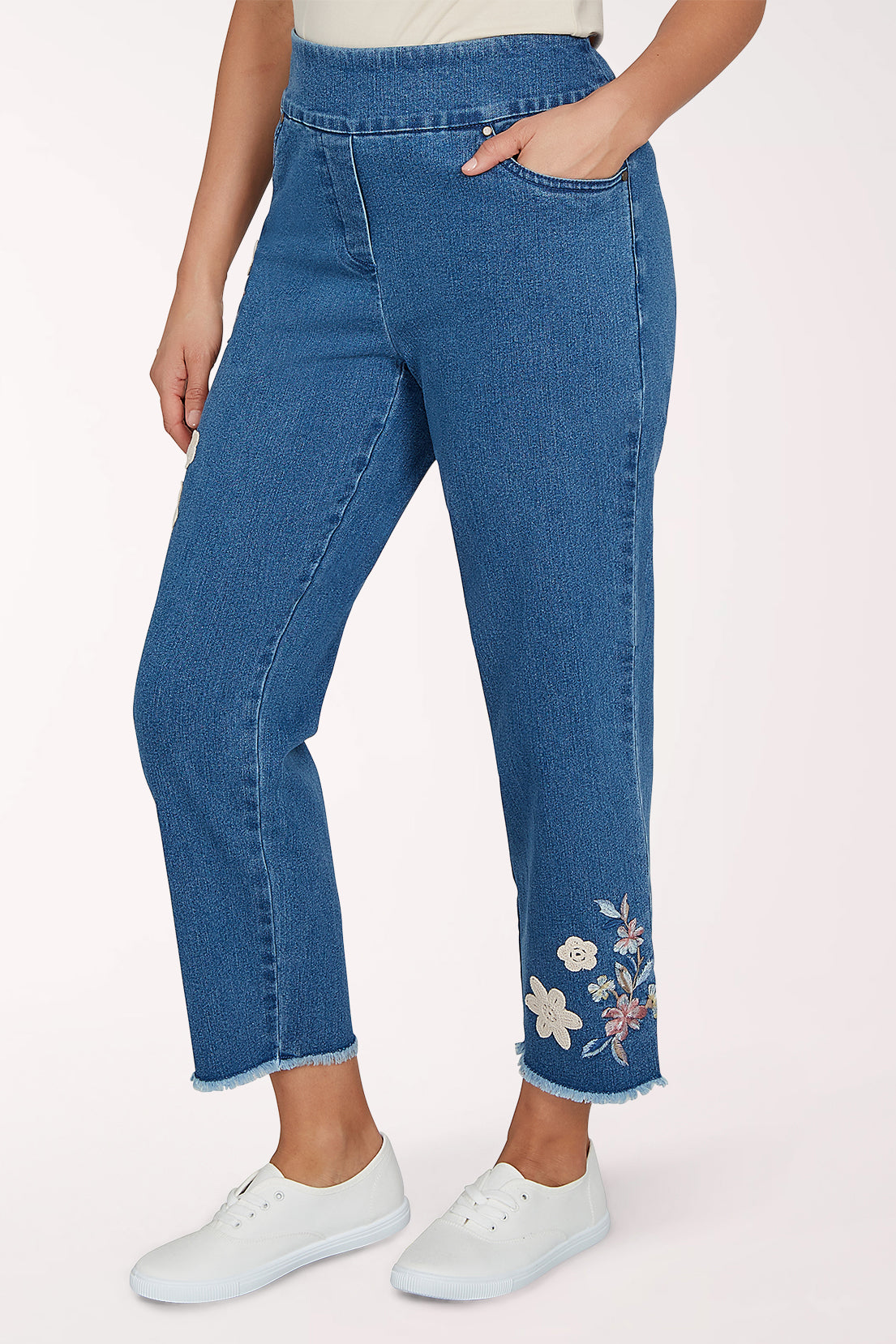 Woman wearing a denim crop pant with a floral design