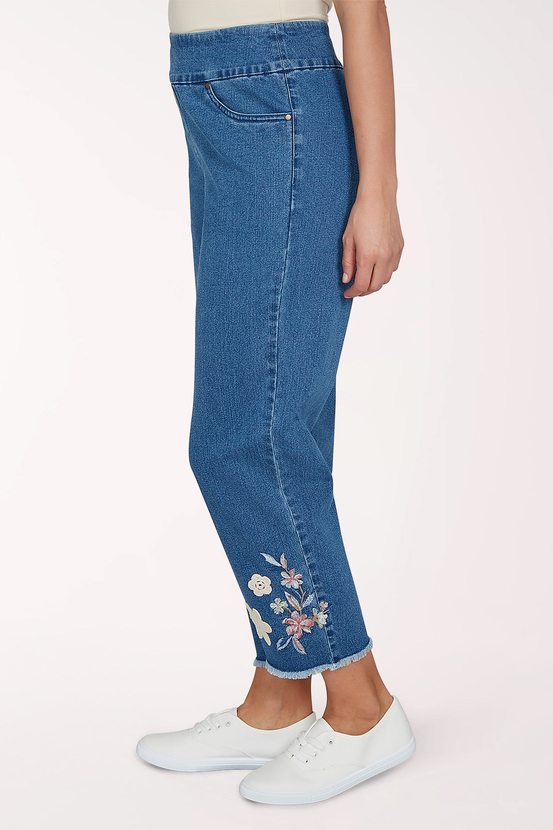 Woman wearing a denim crop pant with a floral design