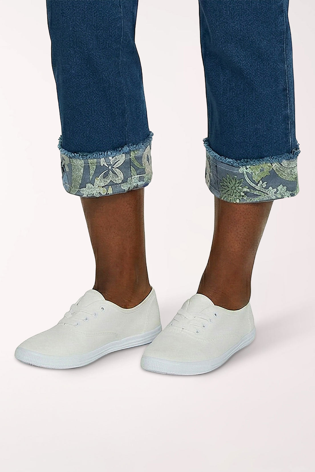 Woman wearing a denim cropped pant with floral hem
