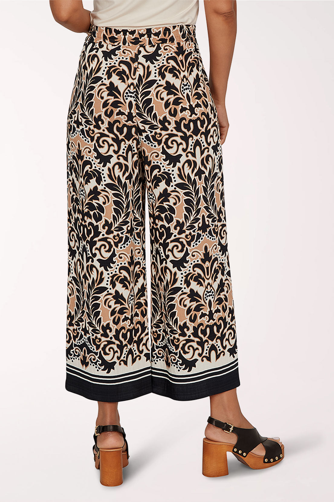 Patterned wide-leg pants worn by a person on a white background