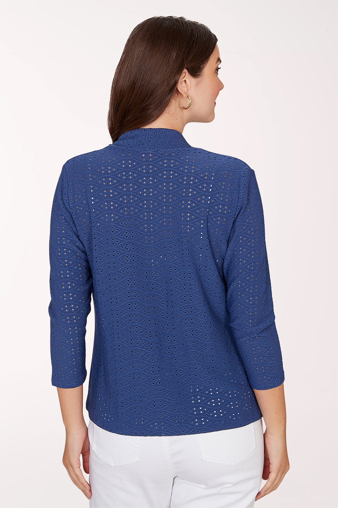 Woman wearing a blue cardigan with a white background