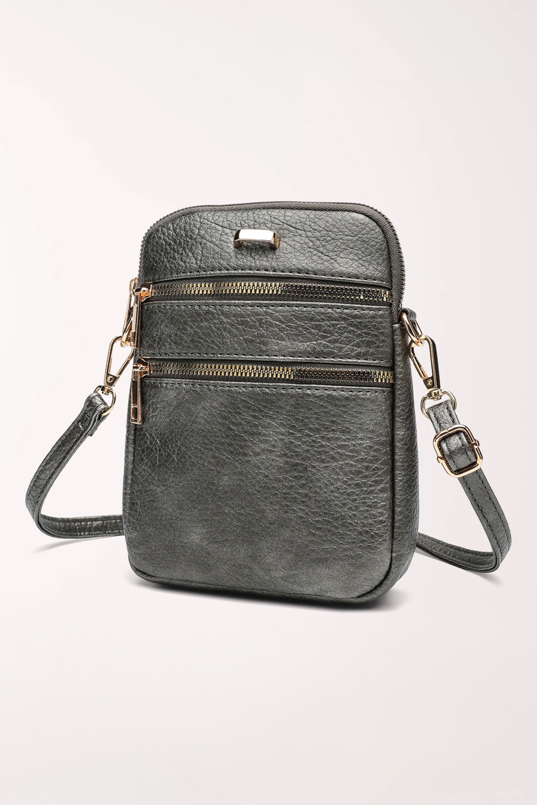 Angled side view of the pewter 22 Tote Three-Pocket Crossbody Bag showing the two front zip pockets, gold hardware and adjustable strap buckle.
