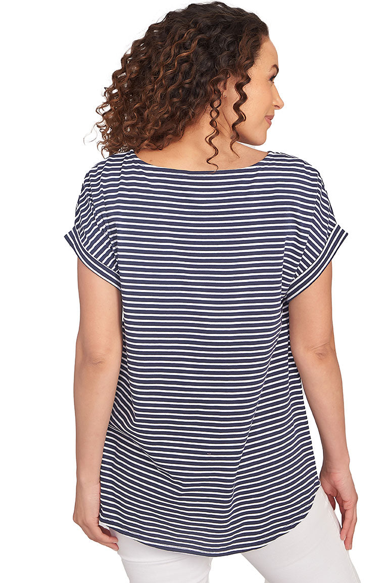 A back shot of a model wearing a navy and white striped tunic with floral designs on a white background