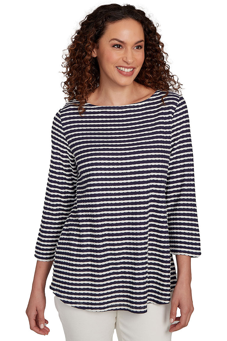 A front shot of a model wearing a navy and white striped shirt on a white background