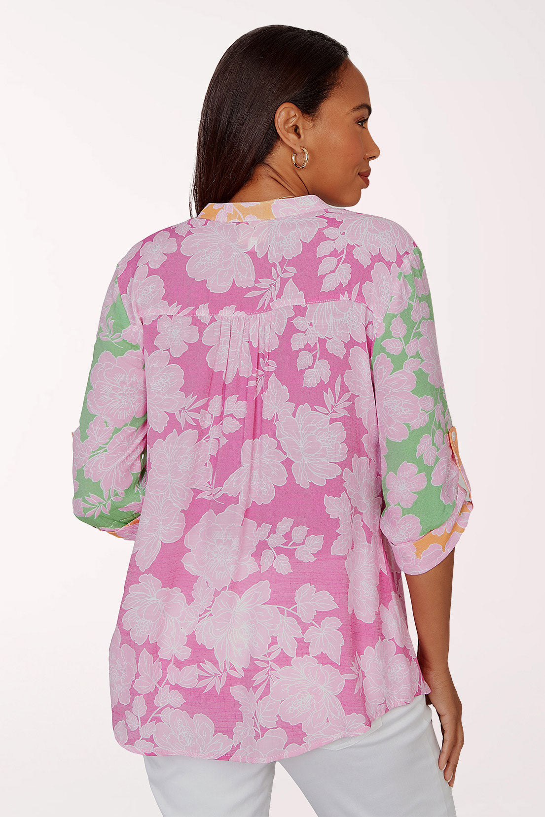 Woman wearing a pink floral blouse on a white background