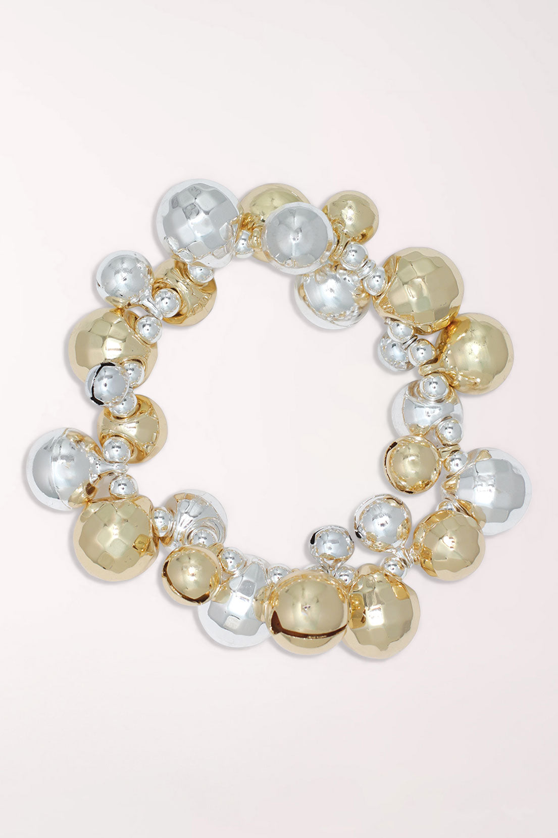 Periwinkle Gold And Silver Jingle Bells Bracelet, a stretch bracelet covered in shiny gold and silver jingle bells with small crystal accents.