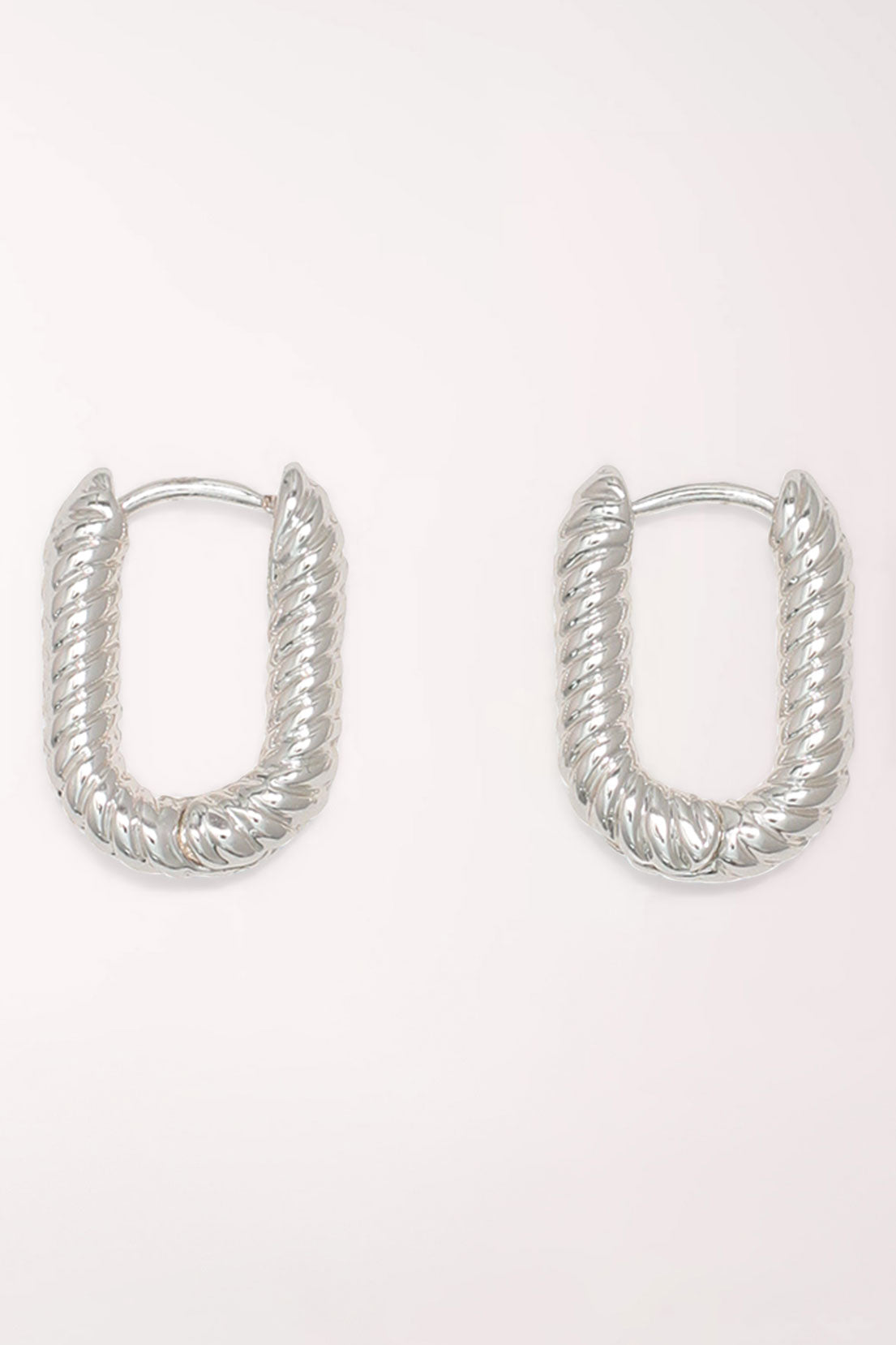 Pair of Periwinkle Silver Ribbed Huggie Hoop Earrings: rounded rectangular silver-tone huggie hoops with a diagonal ribbed, rope-like texture.