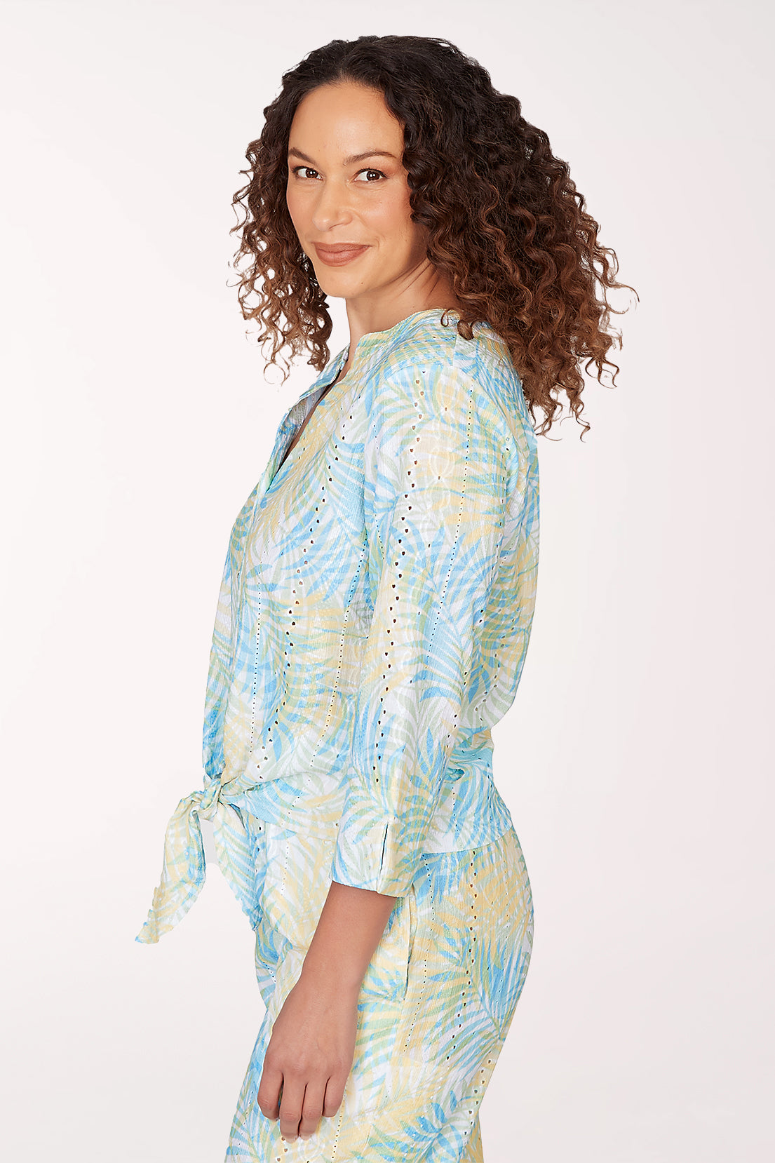 Woman wearing a tie-dye outfit on a white background