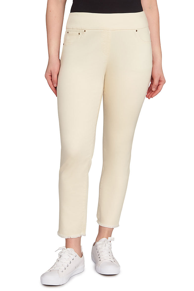 A front shot of a model wearing canvas colored pants paired with sneakers with a white background.