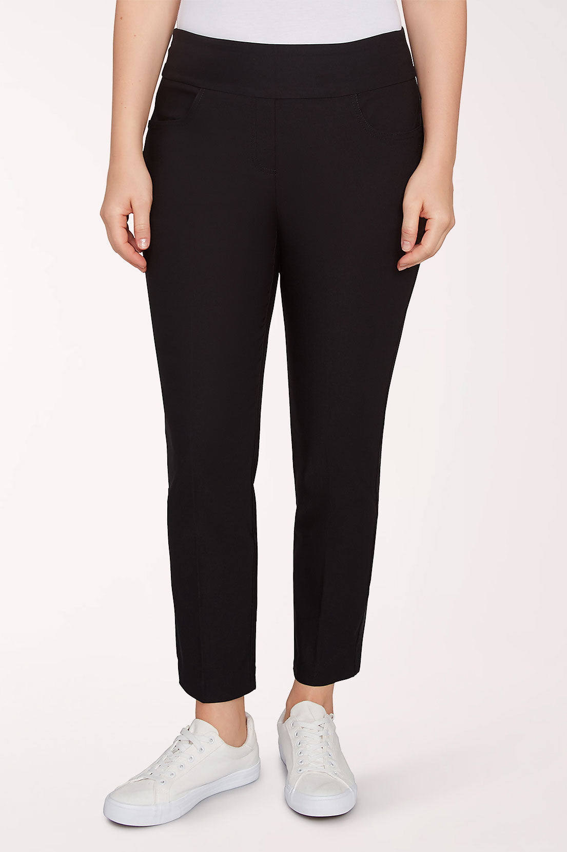 A model wearing black cropped pants and white sneakers, shown from the waist down against a plain light background.