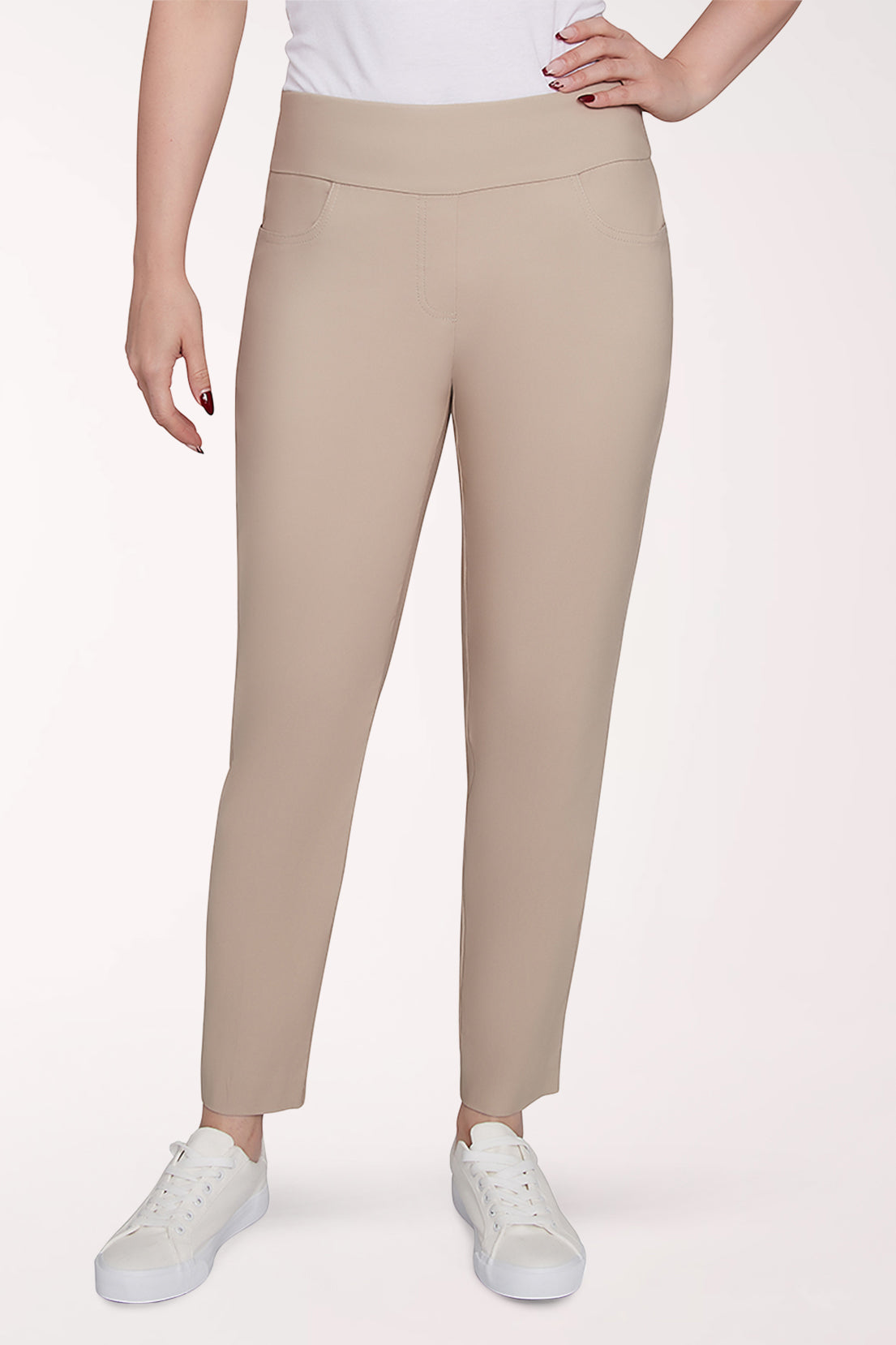 Beige leggings worn by a person on a white background