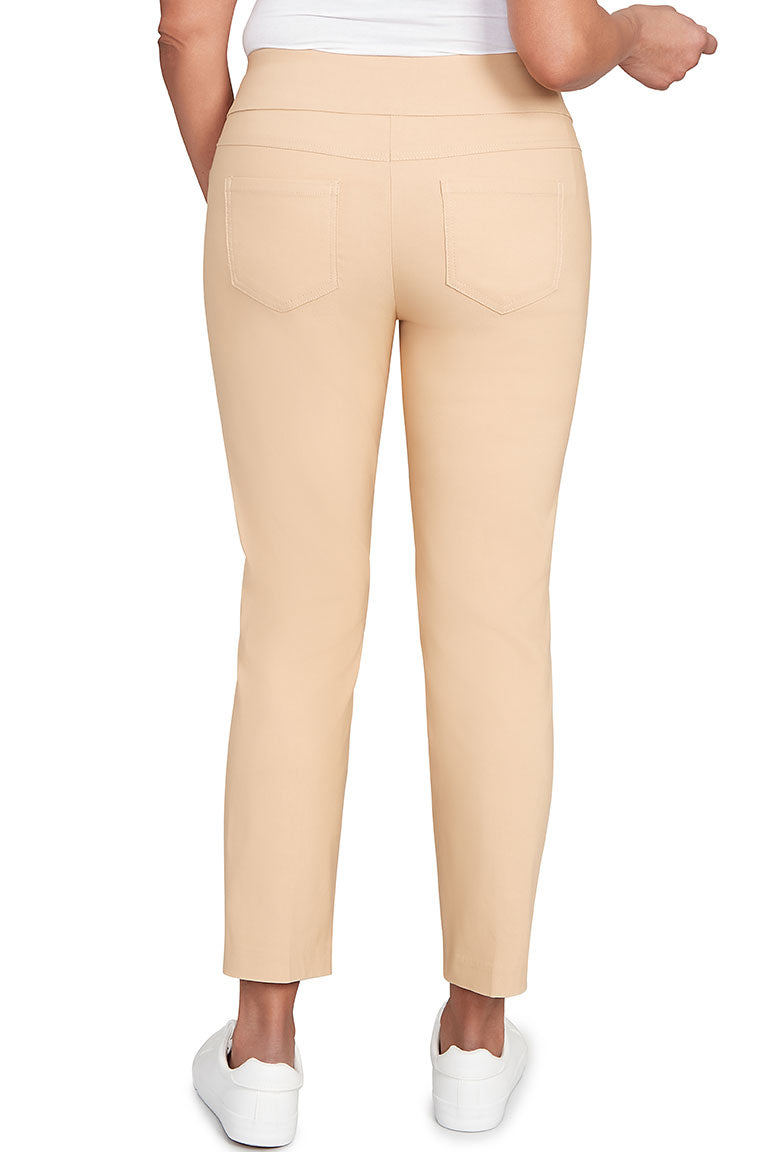 A back shot of a model wearing jute pants paired with white sneakers.