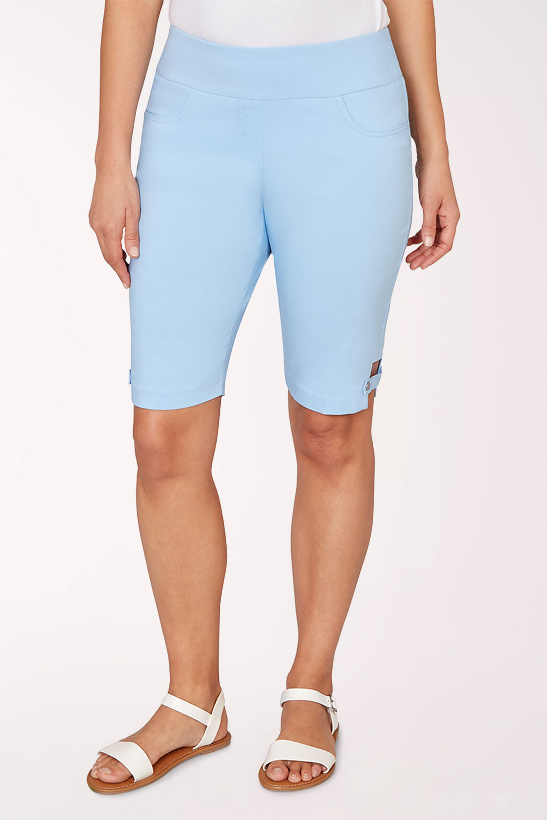 Person wearing light blue shorts on a white background
