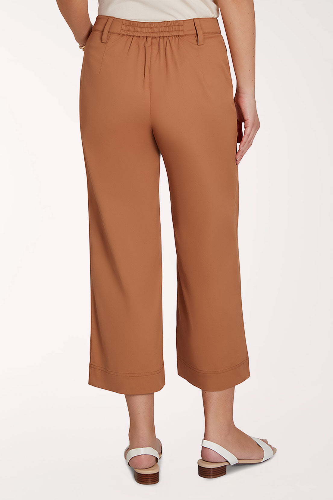 Brown wide-leg pants worn by a person on a white background