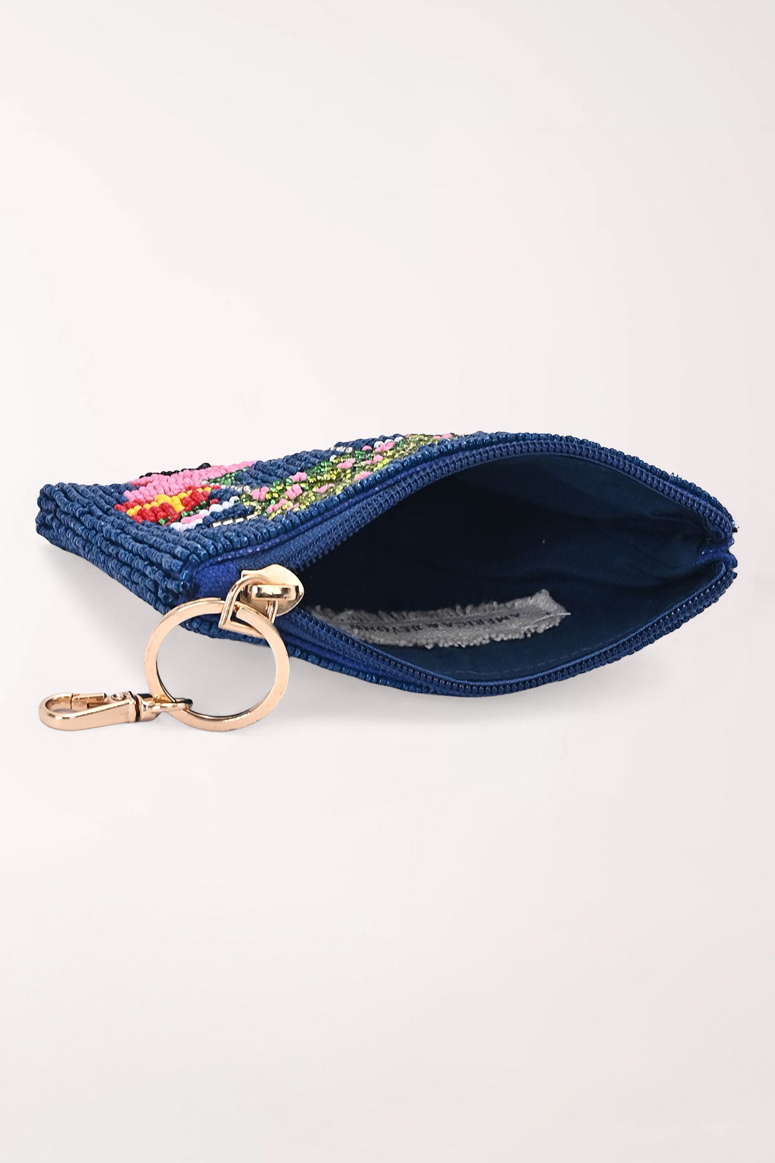 The Merry Carting coin pouch unzipped, showing the navy beading, lined interior and gold key ring clip.