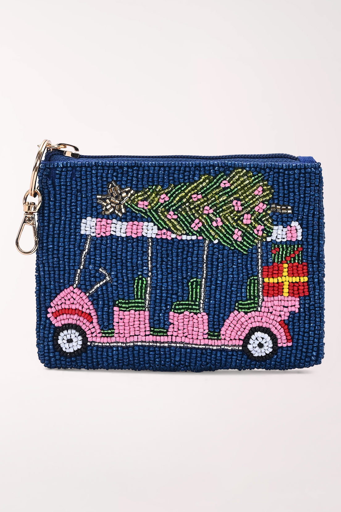 Front view of a navy beaded coin pouch showing a pink golf cart carrying a green Christmas tree and a red wrapped gift, with a gold zipper pull, key ring and dog hook.