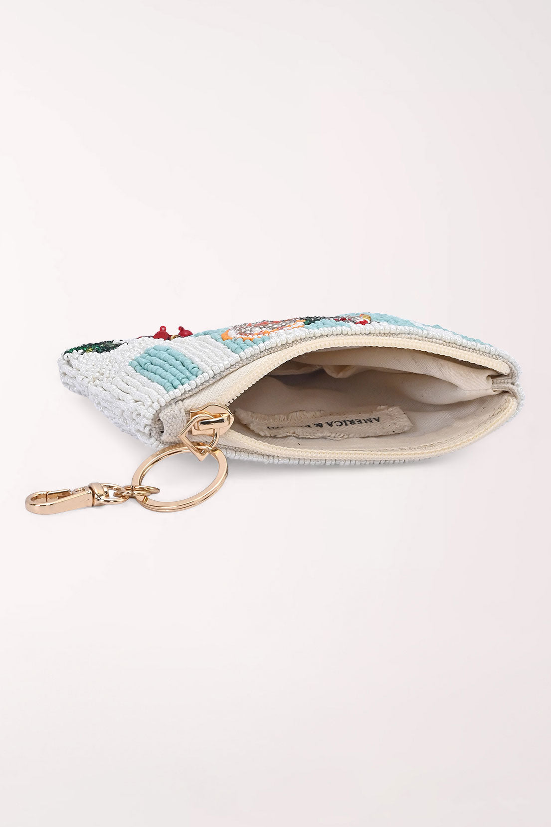 The Merry Mimosa coin pouch unzipped, showing the lined interior and gold key ring clip.