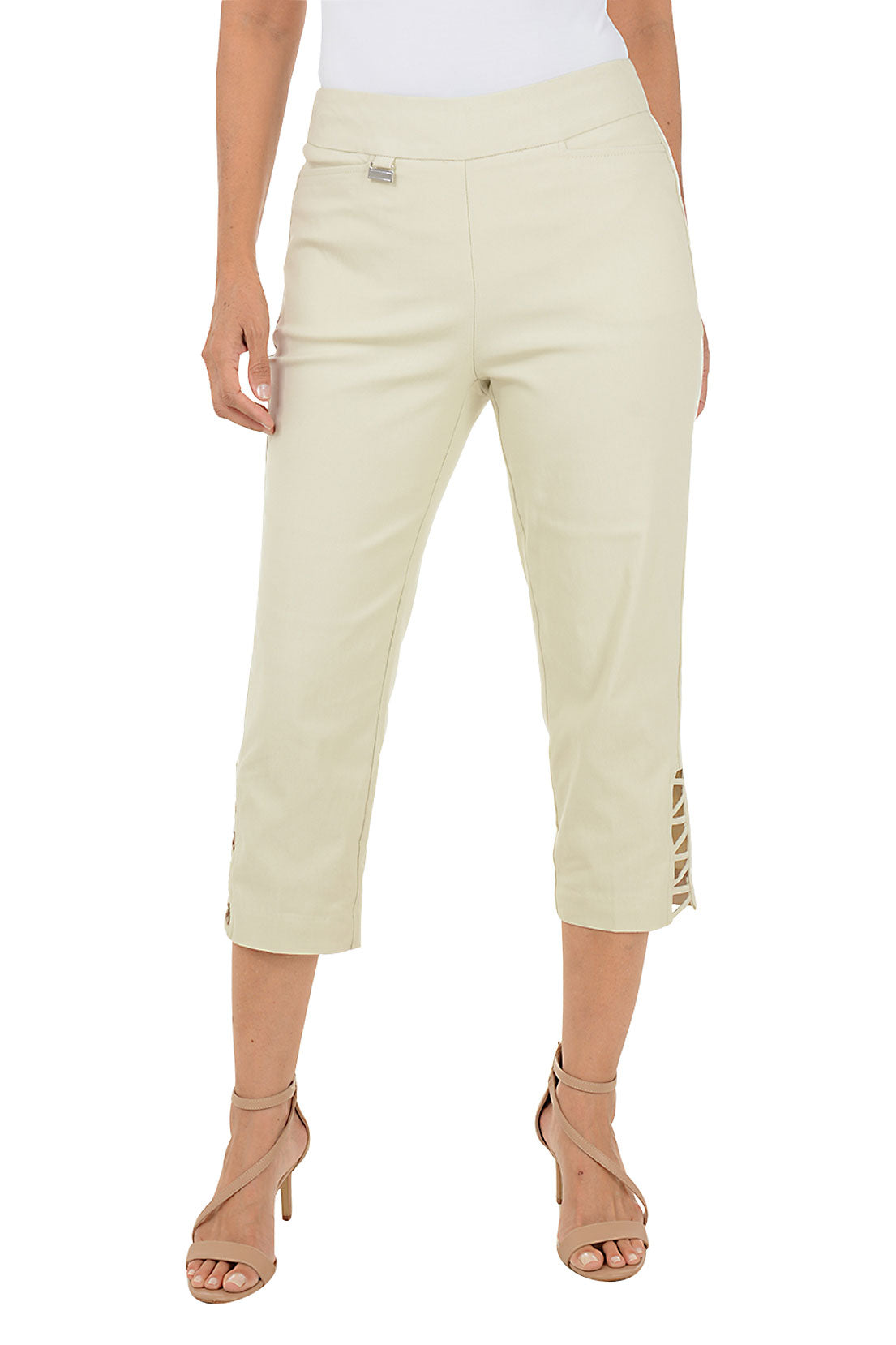 Person wearing beige capri pants with lattice detail on side hem on a white background.