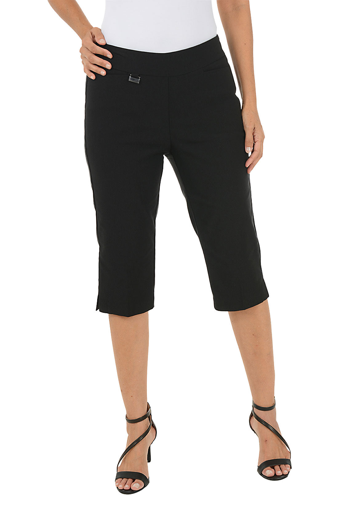 Black capri pants worn by a person on a white background.