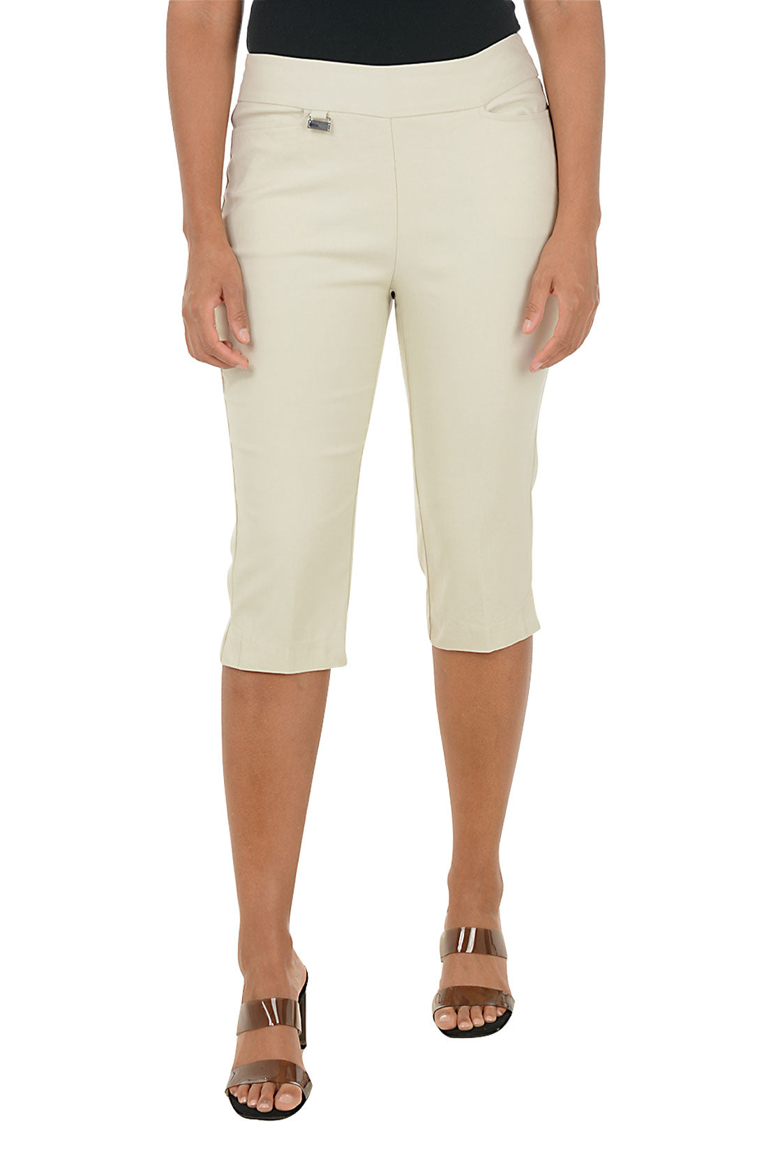 Person wearing beige capri pants on a white background