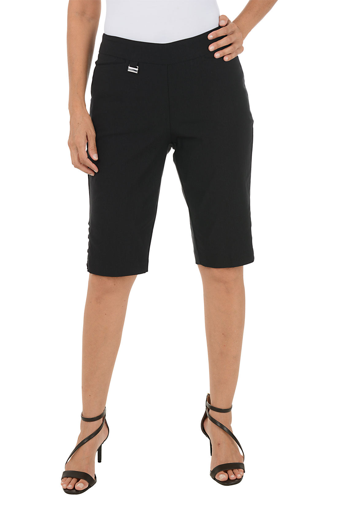 Person wearing black bermuda shorts on a white background.