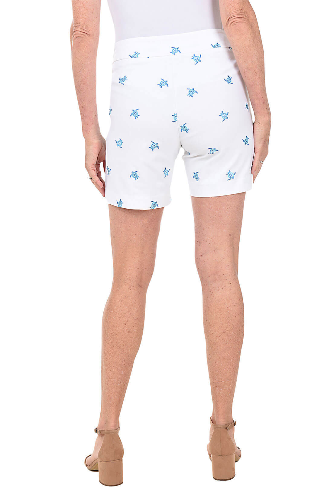 White shorts with blue turtle patterns worn by a person on a white background. Back shot.