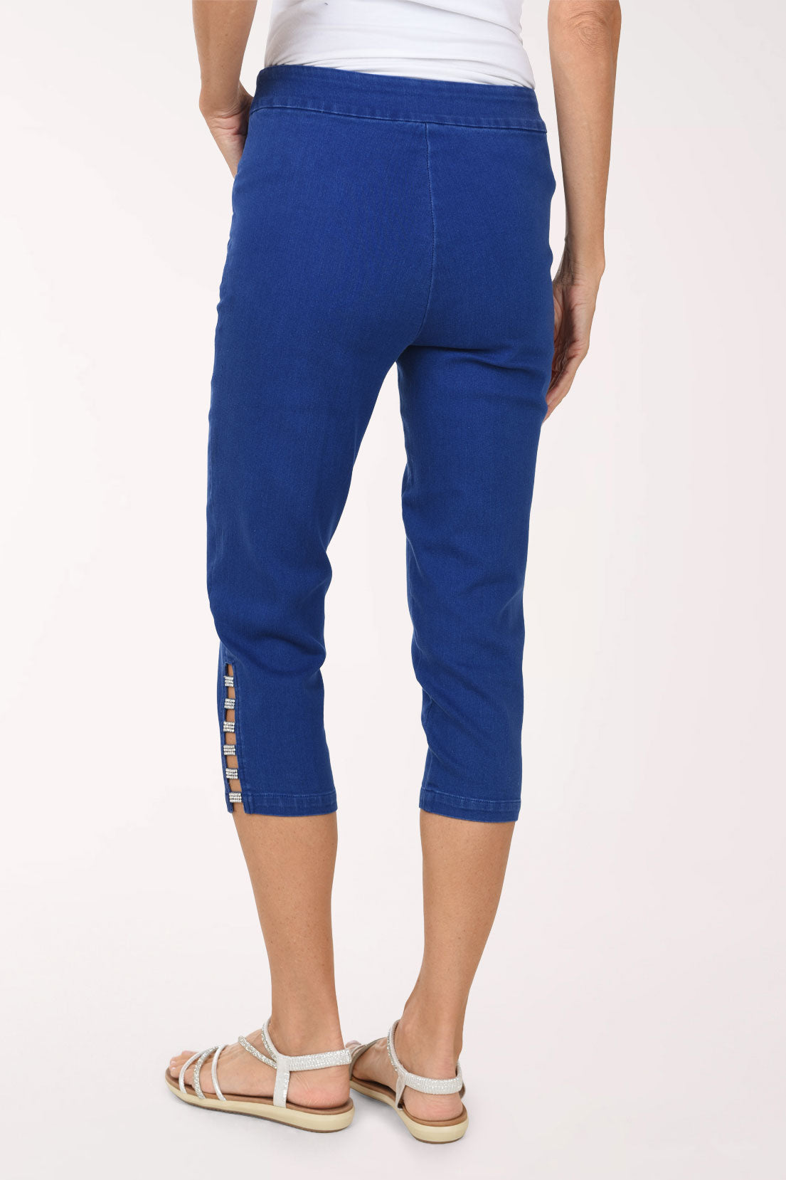 Back view of the Crystal Lattice Hem Denim Capri Pant showing the smooth pull-on back and lattice detail at the outer hem.