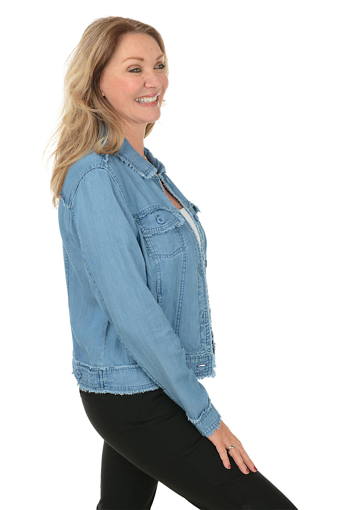 Woman wearing a light blue denim jacket on a white background