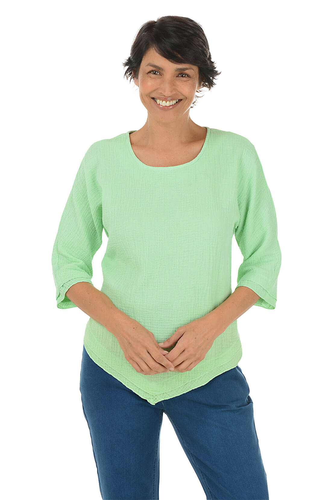 A woman wearing a lime green scoop neck blouse with 3/4 dolman sleeves and a pointed handkerchief hemline.