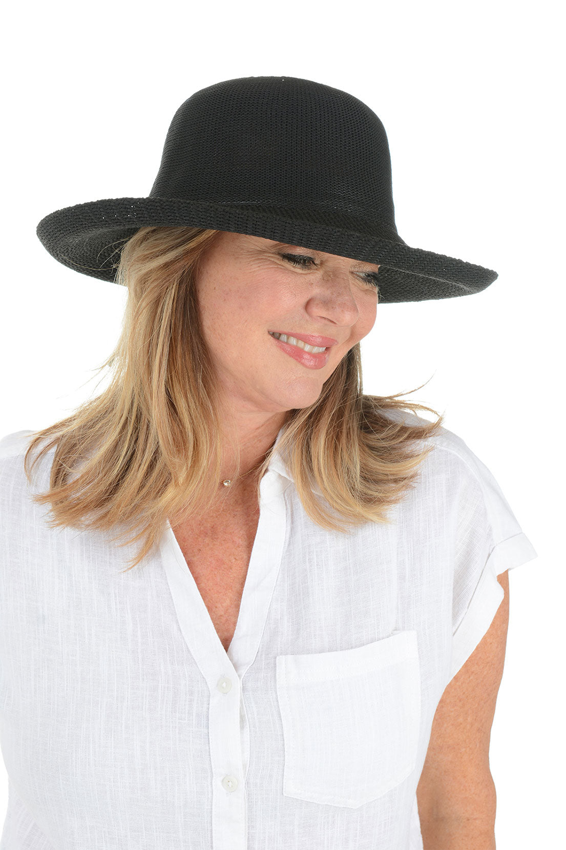 A woman wearing a black woven adjustable travel hat with a wide brim.