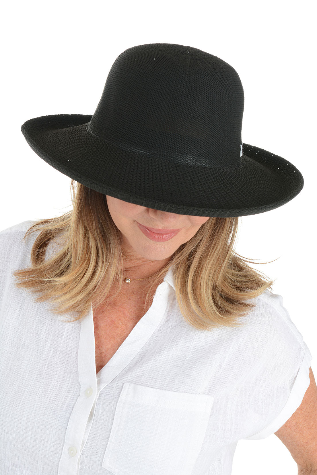 A woman looking down wearing a black woven sun hat with an adjustable tie inner brim.