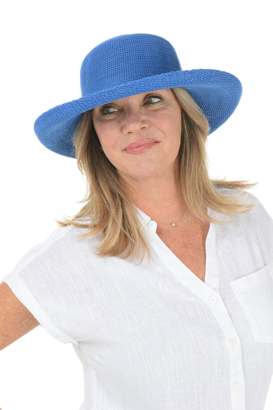 A woman wearing a deep sea green woven sun hat with an adjustable tie inner brim.