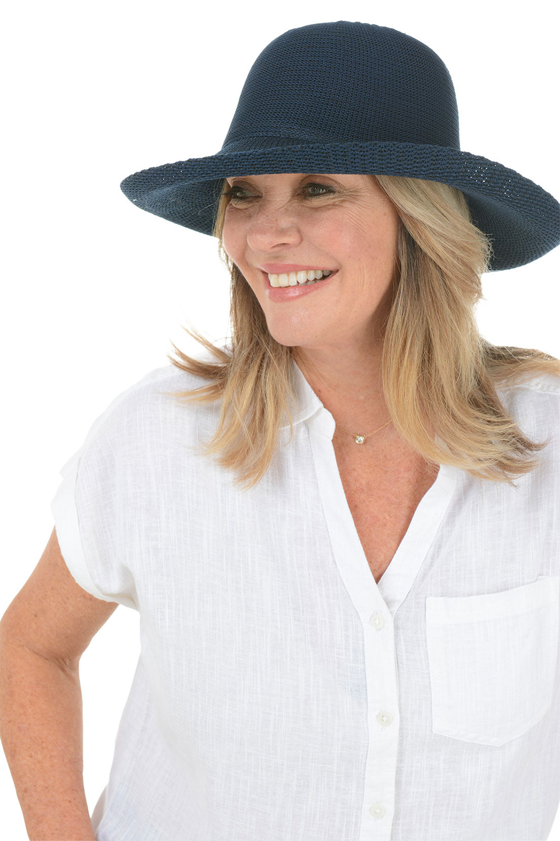 A woman wearing a navy woven sun hat with an adjustable tie inner brim.