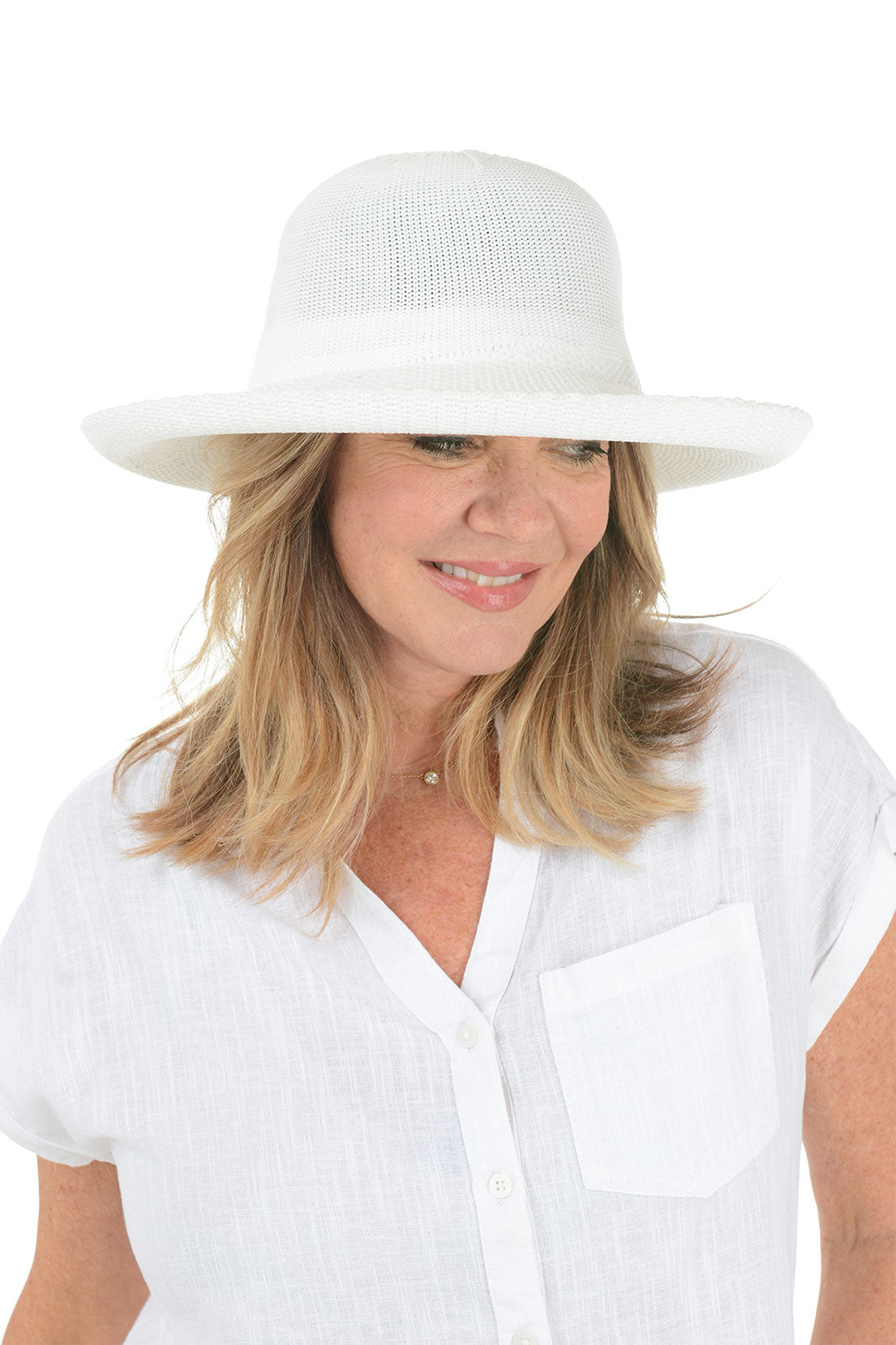 A woman wearing a white woven sun hat with an adjustable tie inner brim.