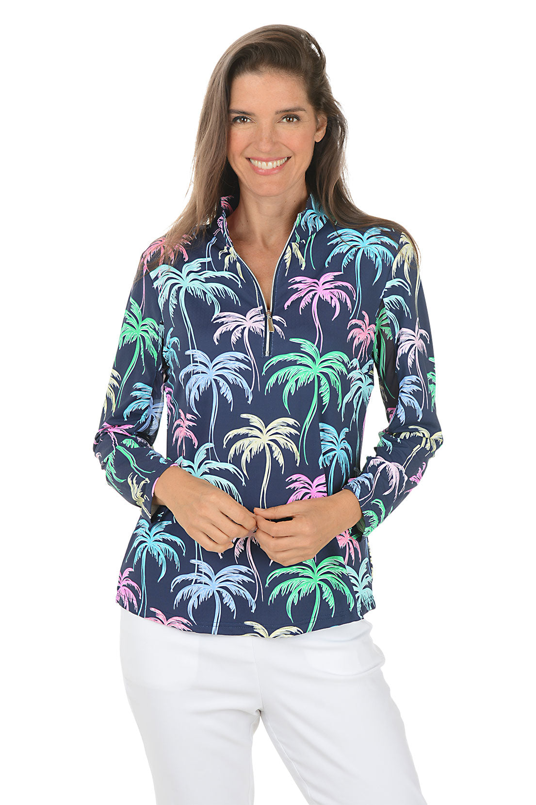 Woman wearing a colorful palm tree patterned shirt on a white background.