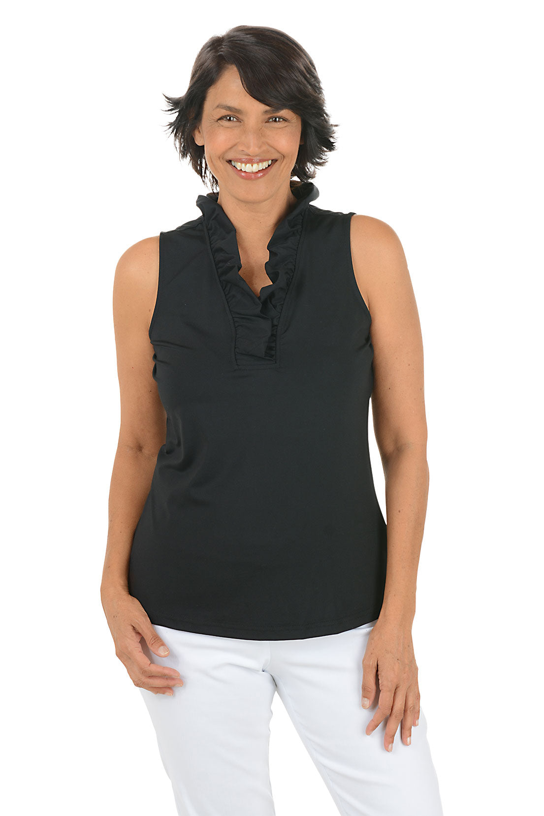 Woman wearing a black sleeveless top with ruffles and white pants on a white background.