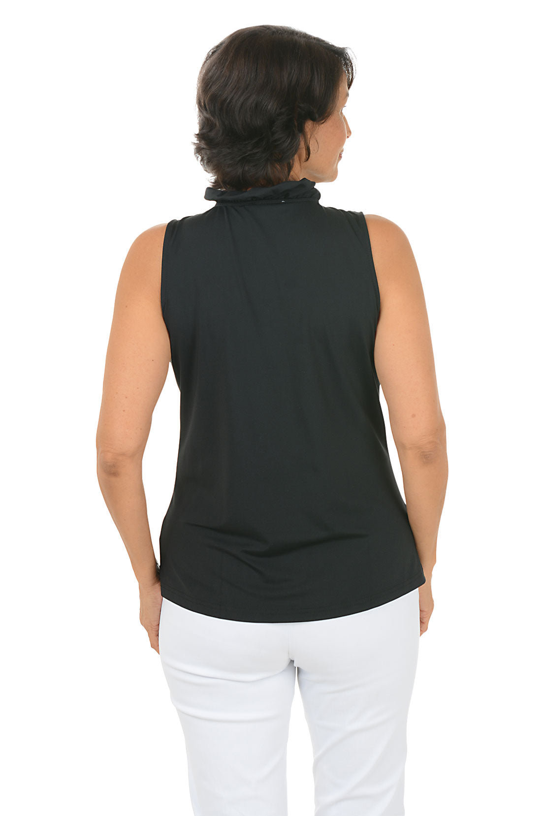 Woman wearing a black sleeveless top with ruffles and white pants on a white background. Back shot.