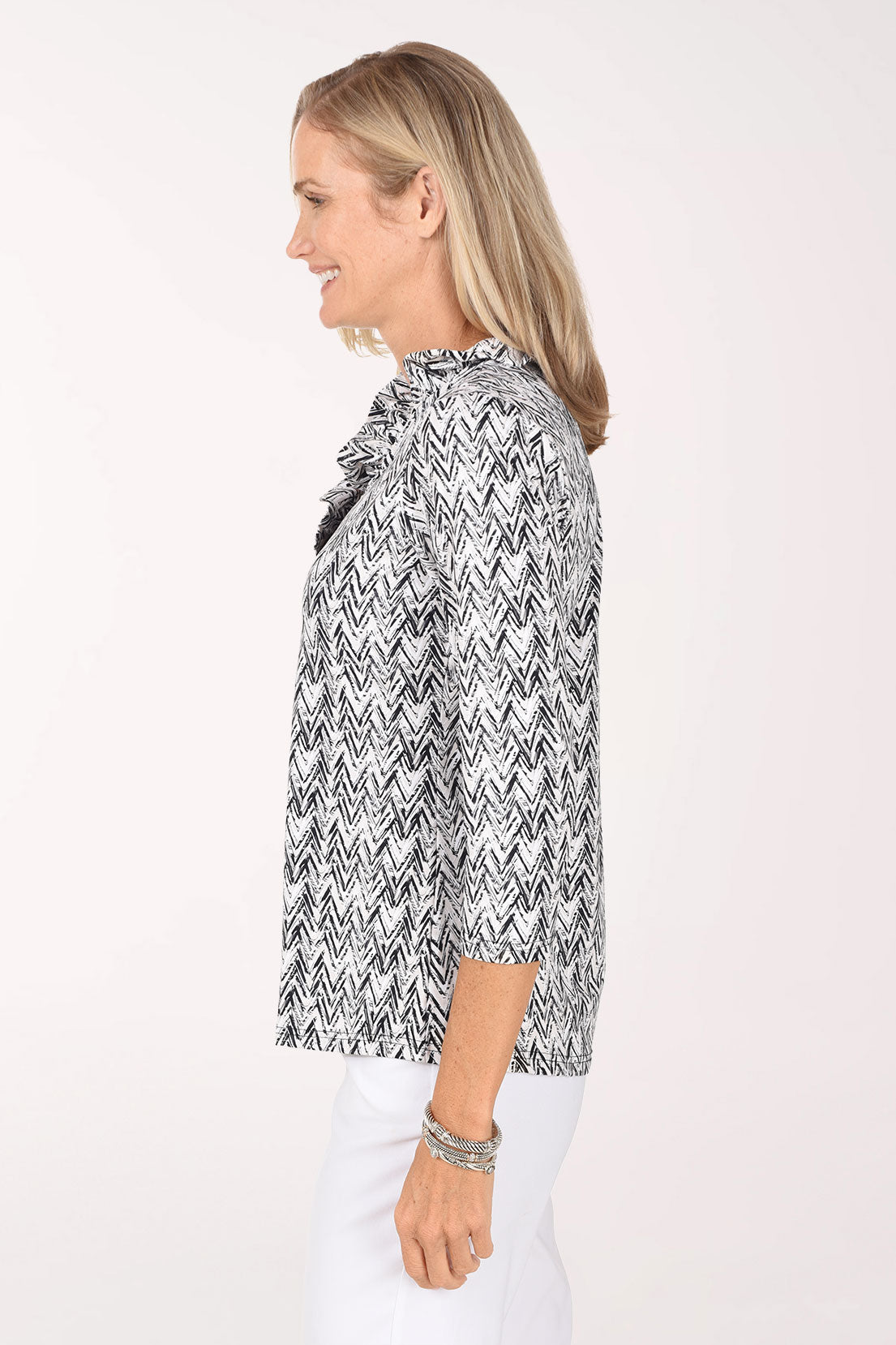 Side view of the Neutral Chevron Ruffle Neck Top showing the ruffled neckline and 3/4-length sleeves.