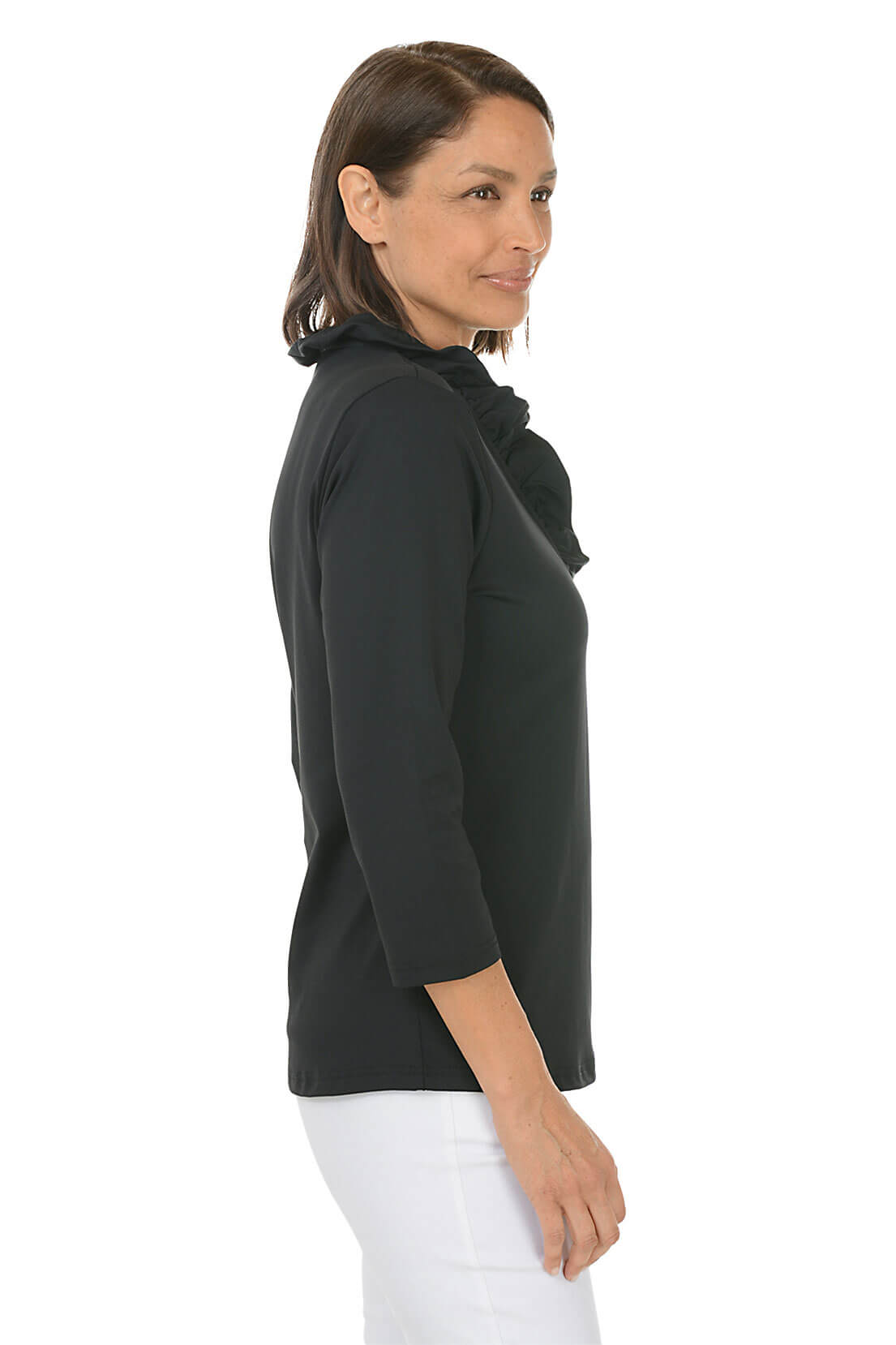 Woman wearing a black top and white pants on a white background